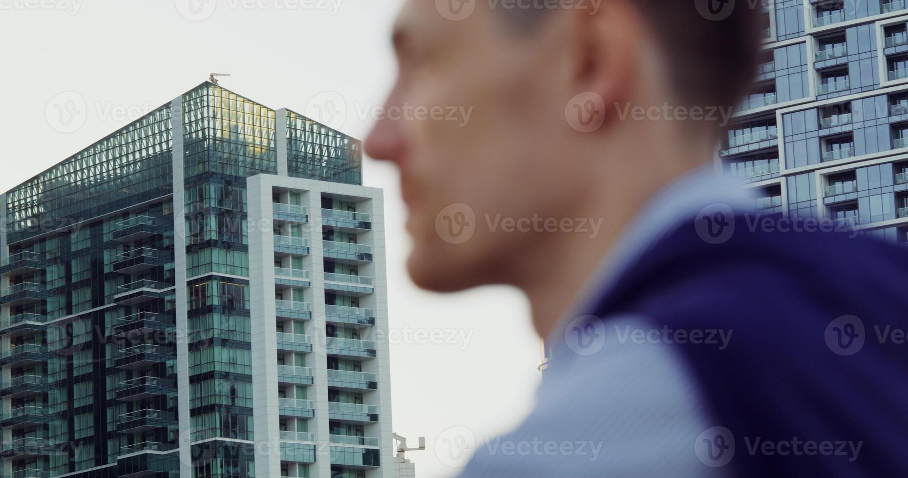 A man is standing in front of a building photo