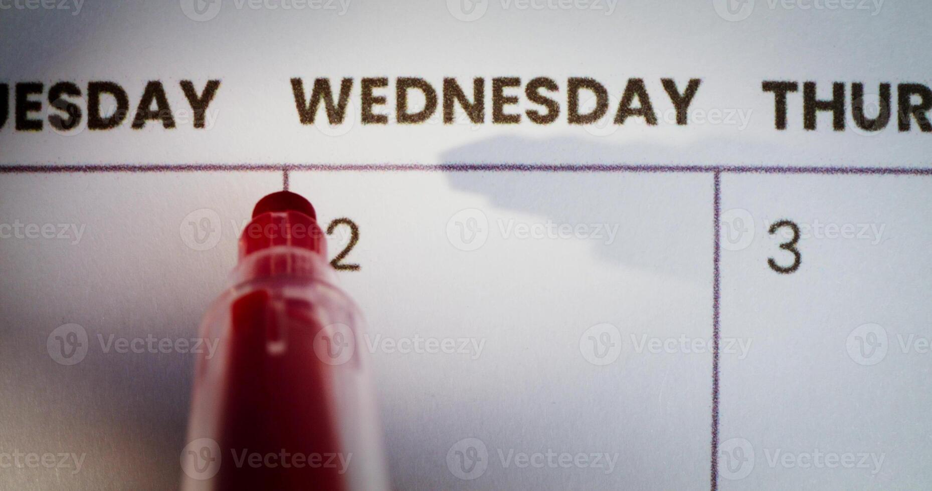 Calendar with red pen on wednesday photo