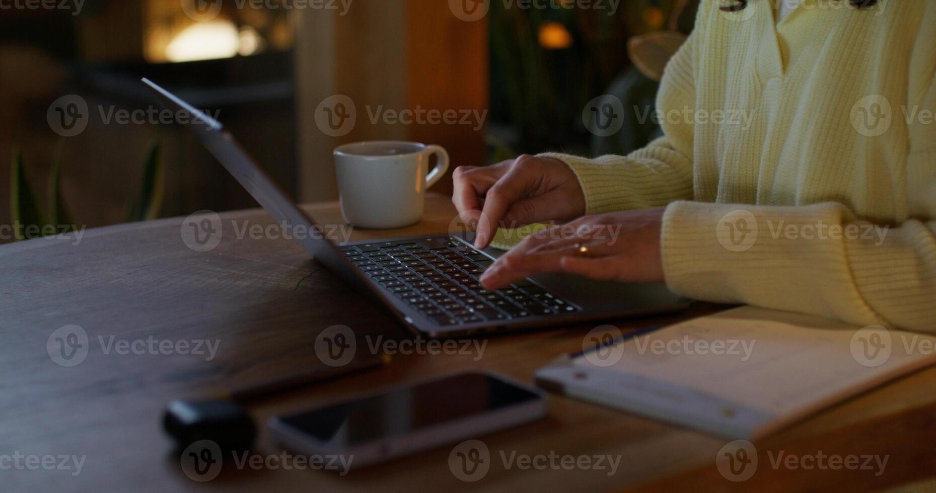 A woman typing on a laptop photo