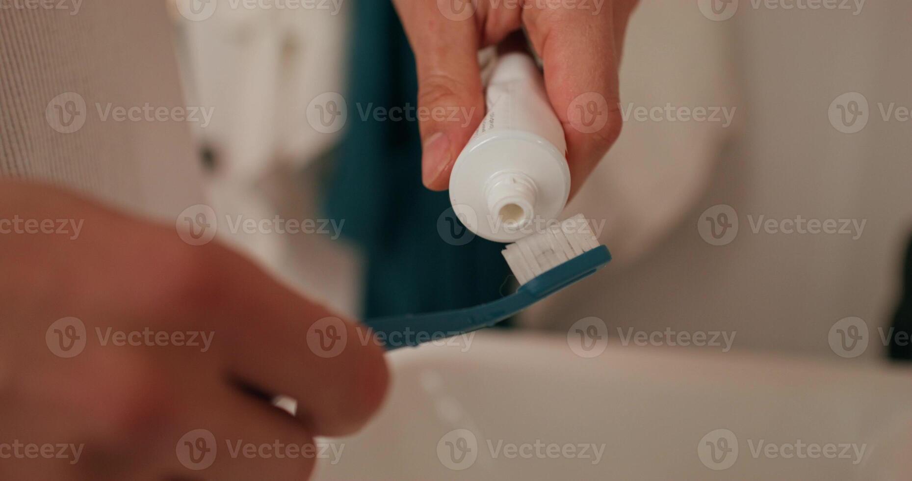 puting toothpaste on a toothbrush photo