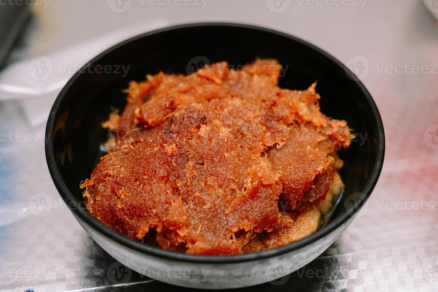 Delicious caramelized coconut jam served in a bowl for a delightful treat photo