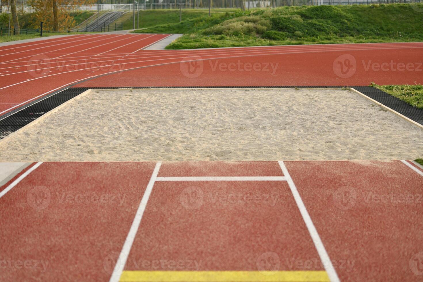 Sand pit for long jump at the stadium photo