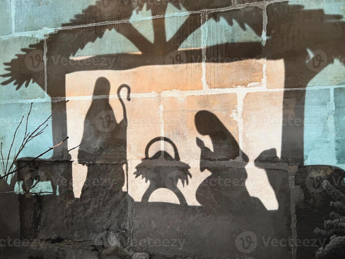 Reflection on the wall of christmas creche with Joseph Mary and small Jesus in a crib photo