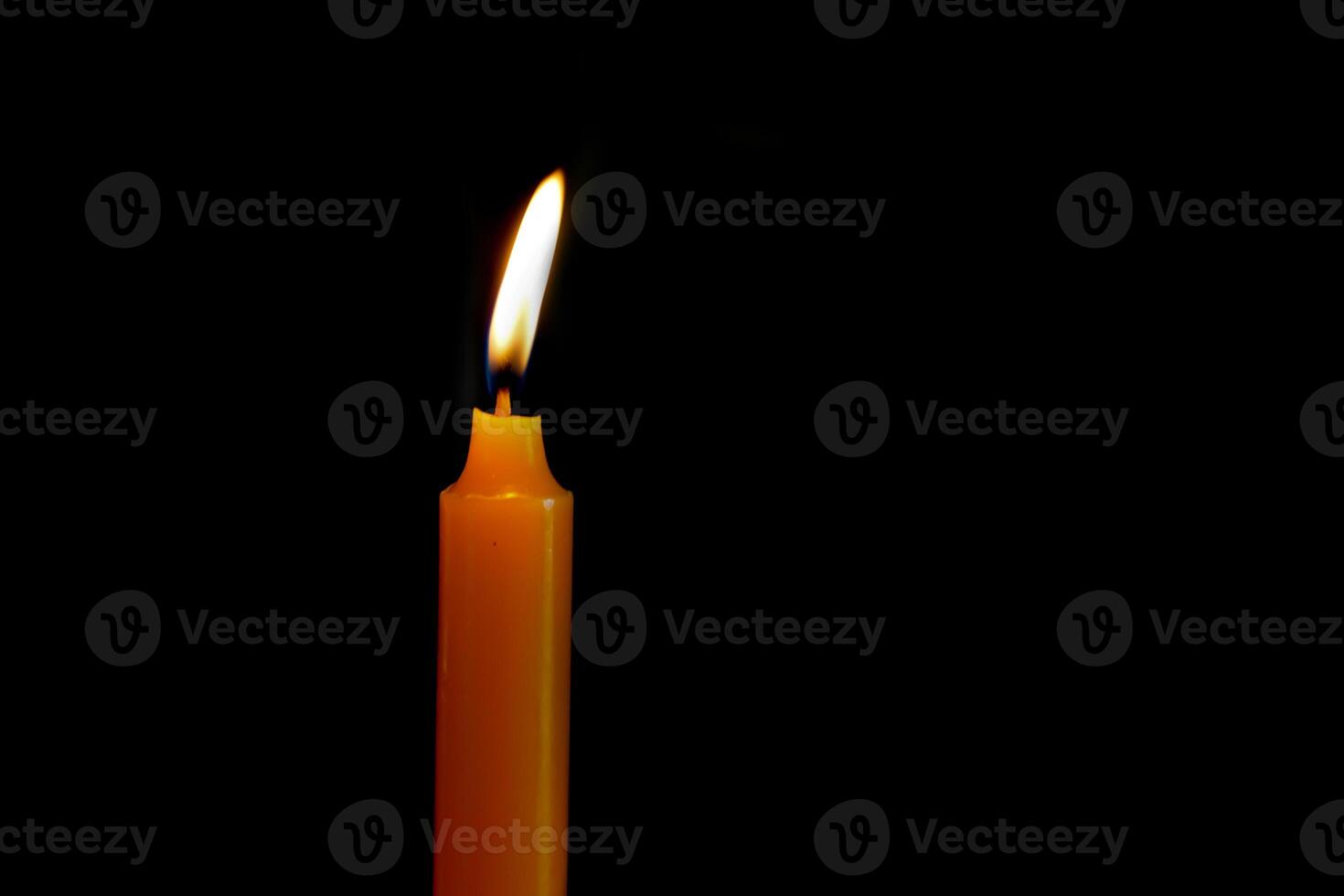 Candle light on black background of darkness at night. Soft and selective focus. photo
