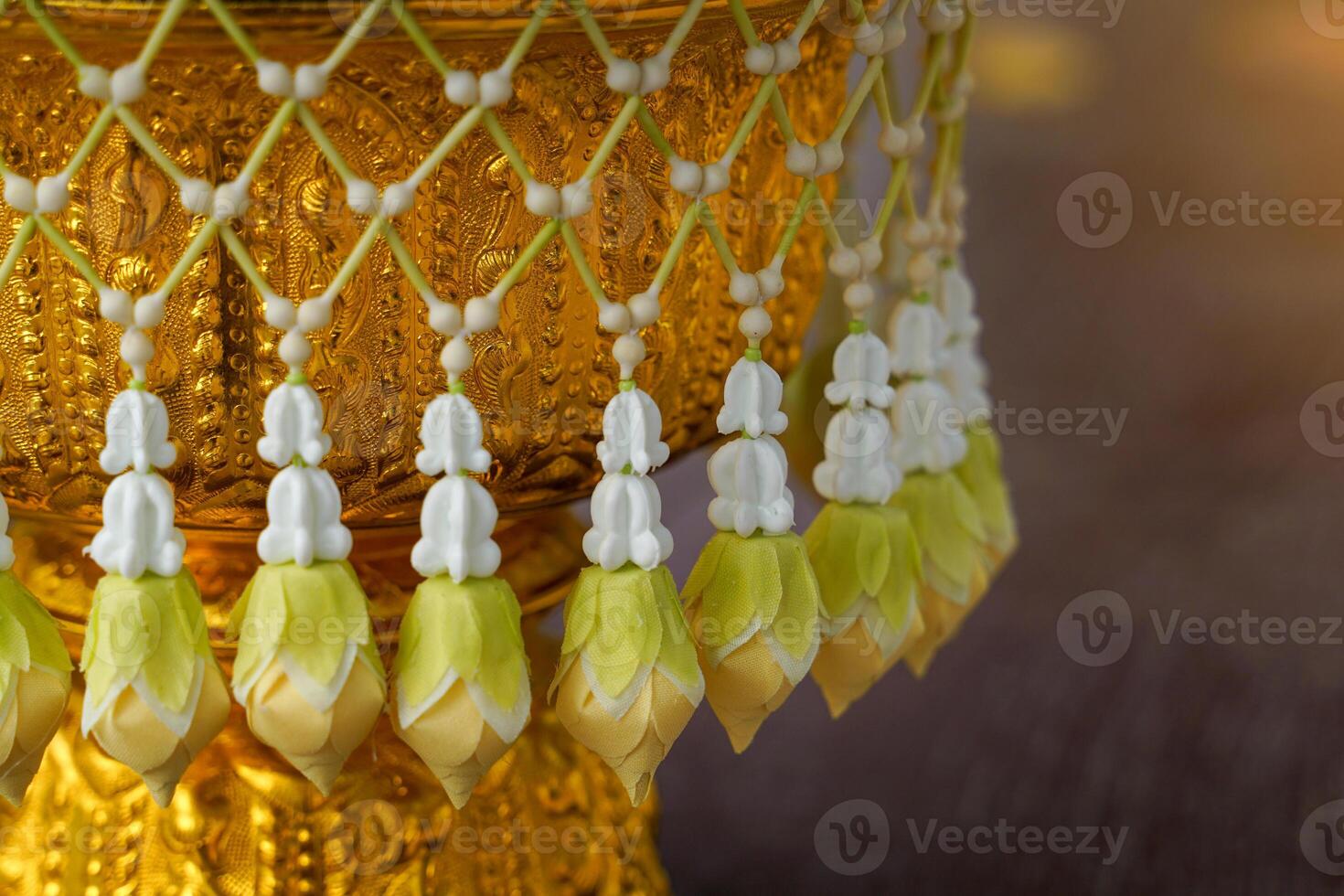 Uba is a flower that is strung in a string and attached to a bunch like a tassel for hanging on a tray with a pedestal or a flower garland photo
