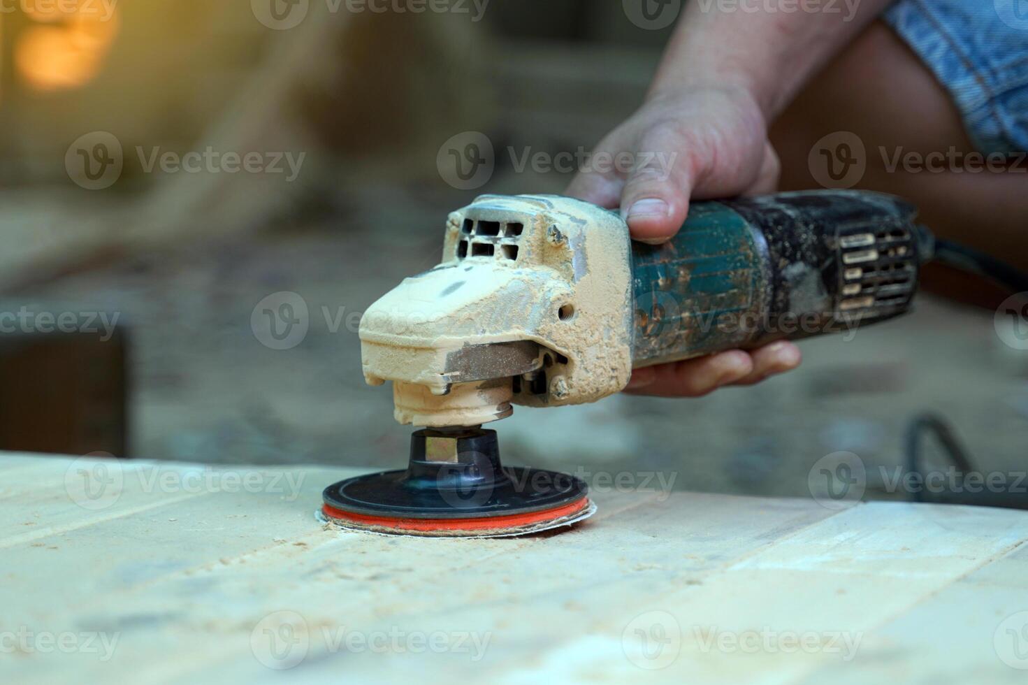 Carpenters use a sander to sand the surface of the wood to smooth the woodwork before painting. photo