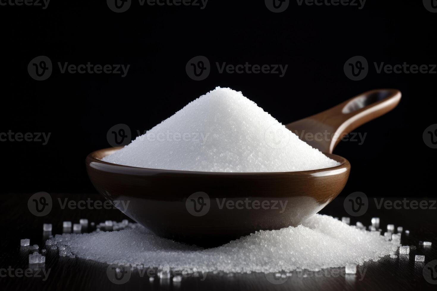 granulated sugar on the table on a black background photo