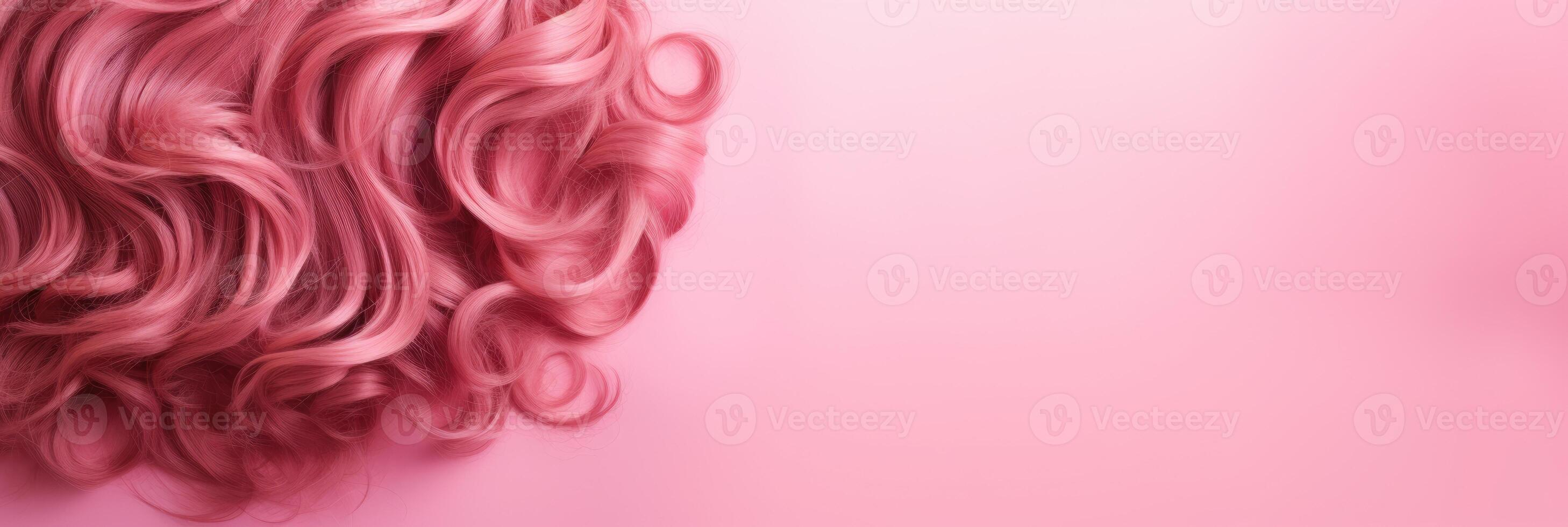 Wavy texture of healthy colored curly pink hair isolated on pink background, baner. photo