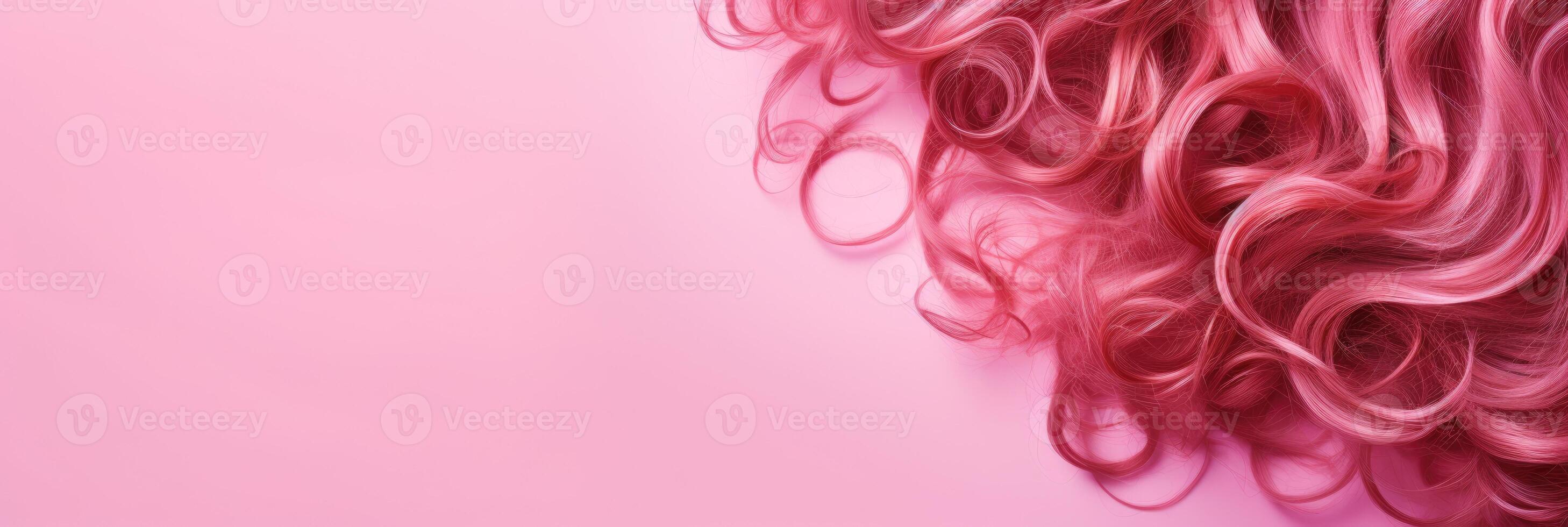 Wavy texture of healthy colored curly pink hair isolated on pink background, baner. photo