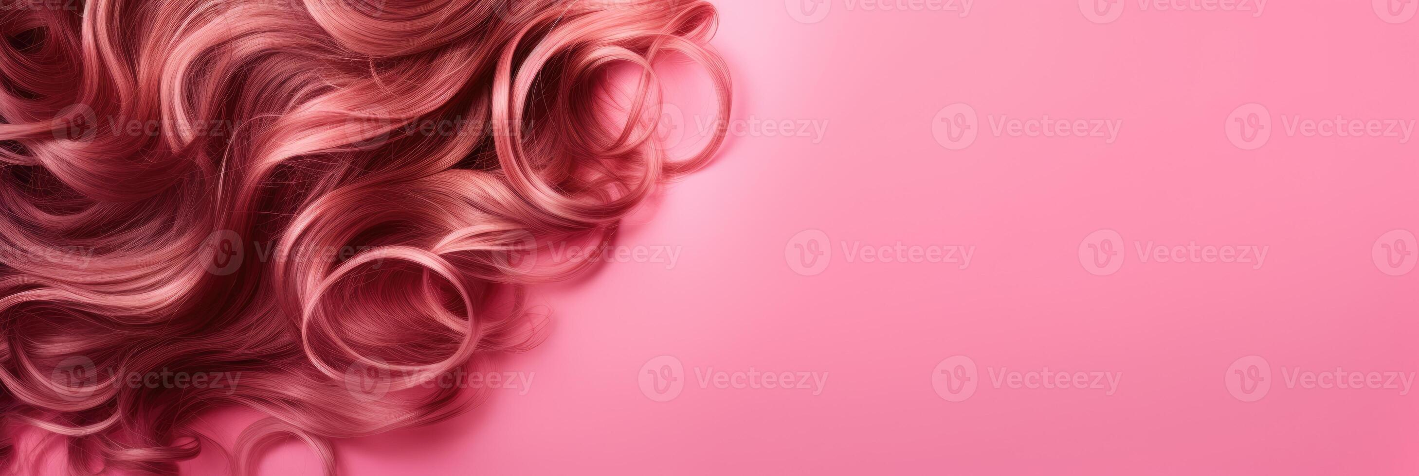 Wavy texture of healthy colored curly pink hair isolated on pink background, baner. photo