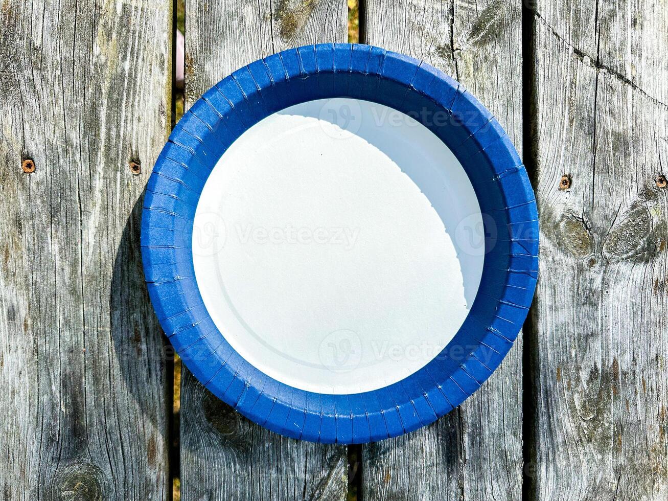 Empty Plate Top View Isolated on wooden Background. photo