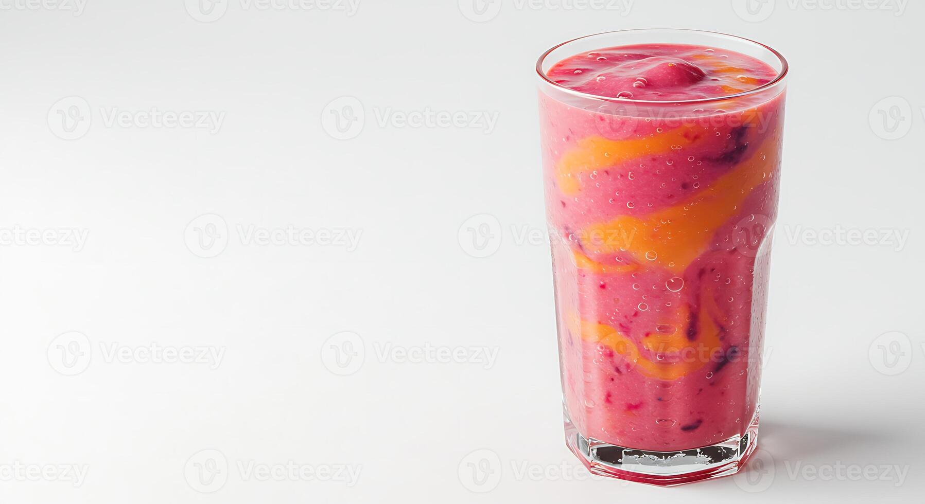 Serving of Colorful Fruit Smoothie in Glass on White Background photo