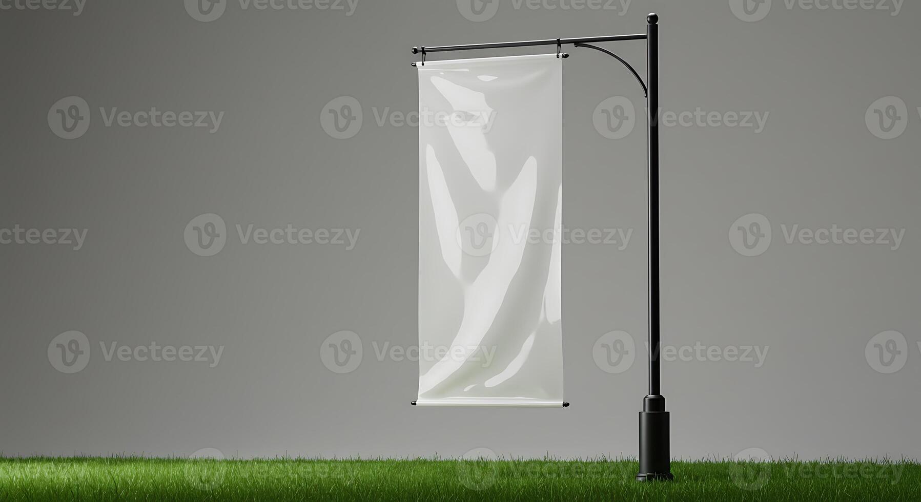 Blank Banner Mockup on Pole Standing in Green Grass Field photo