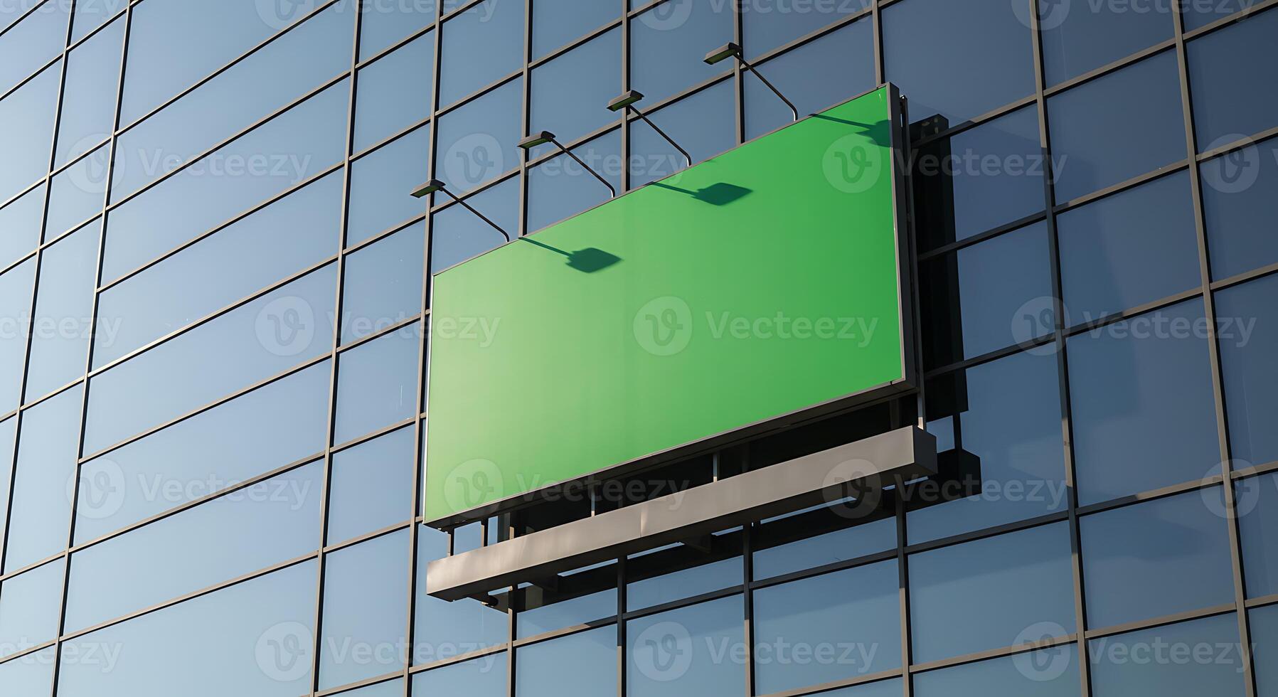 Green Billboard Attached to Modern Glass Building Reflecting Blue Sky photo