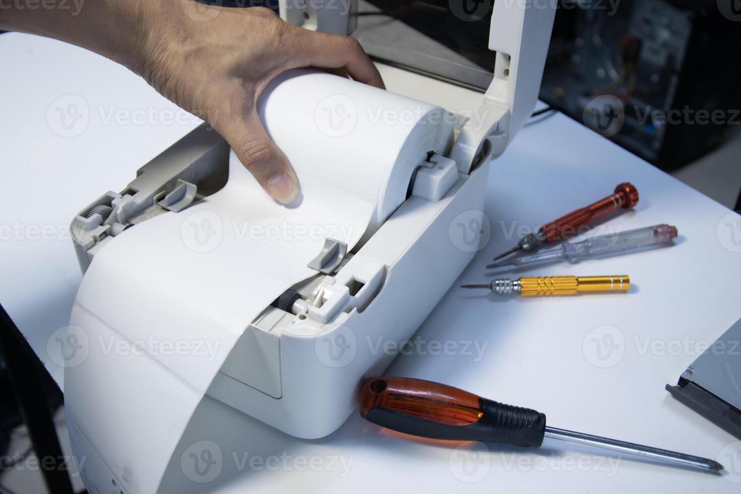 Top view. Technician repairing printer, label printer photo