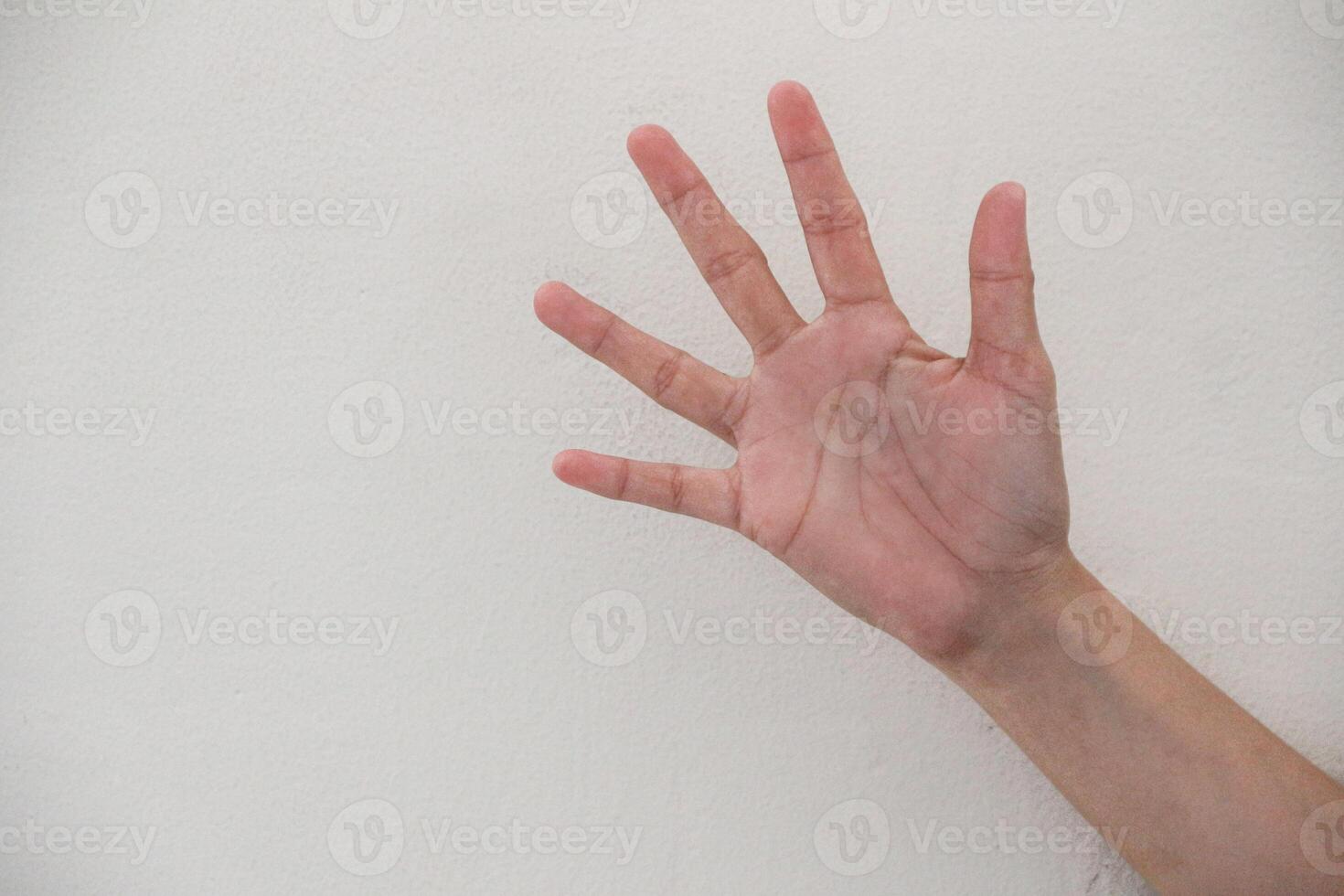 Close-up of hand showing number five gesture isolated on white background. photo
