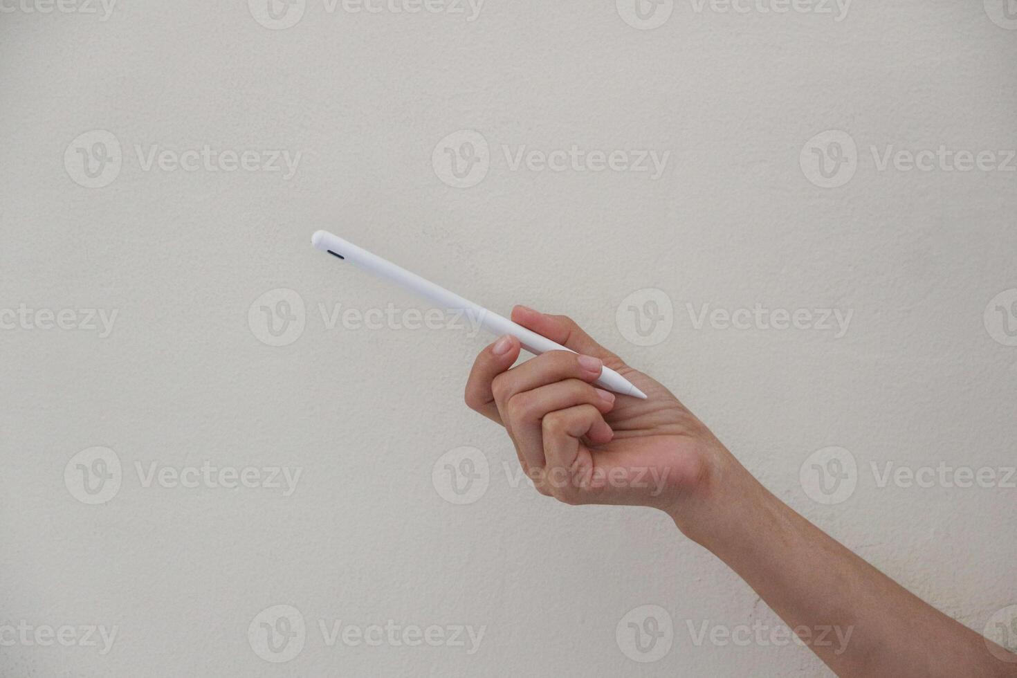 Technology Concept. One Hand using Tablet in Vertical axis with white stylus or pen and free screen on white background and clipping path. photo