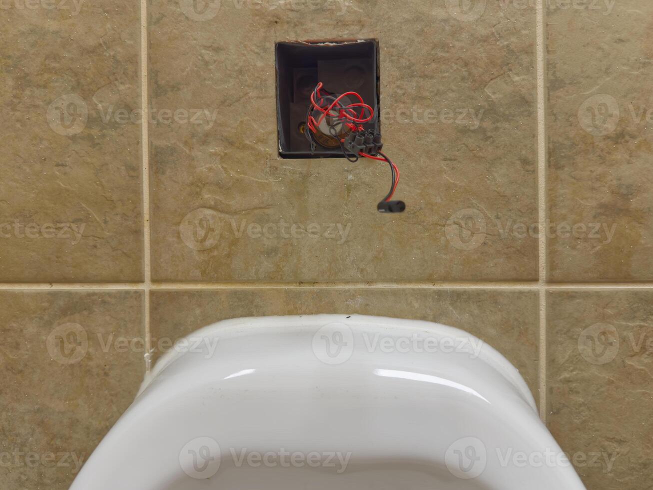 Toilet with Visible Plumbing and Wiring photo