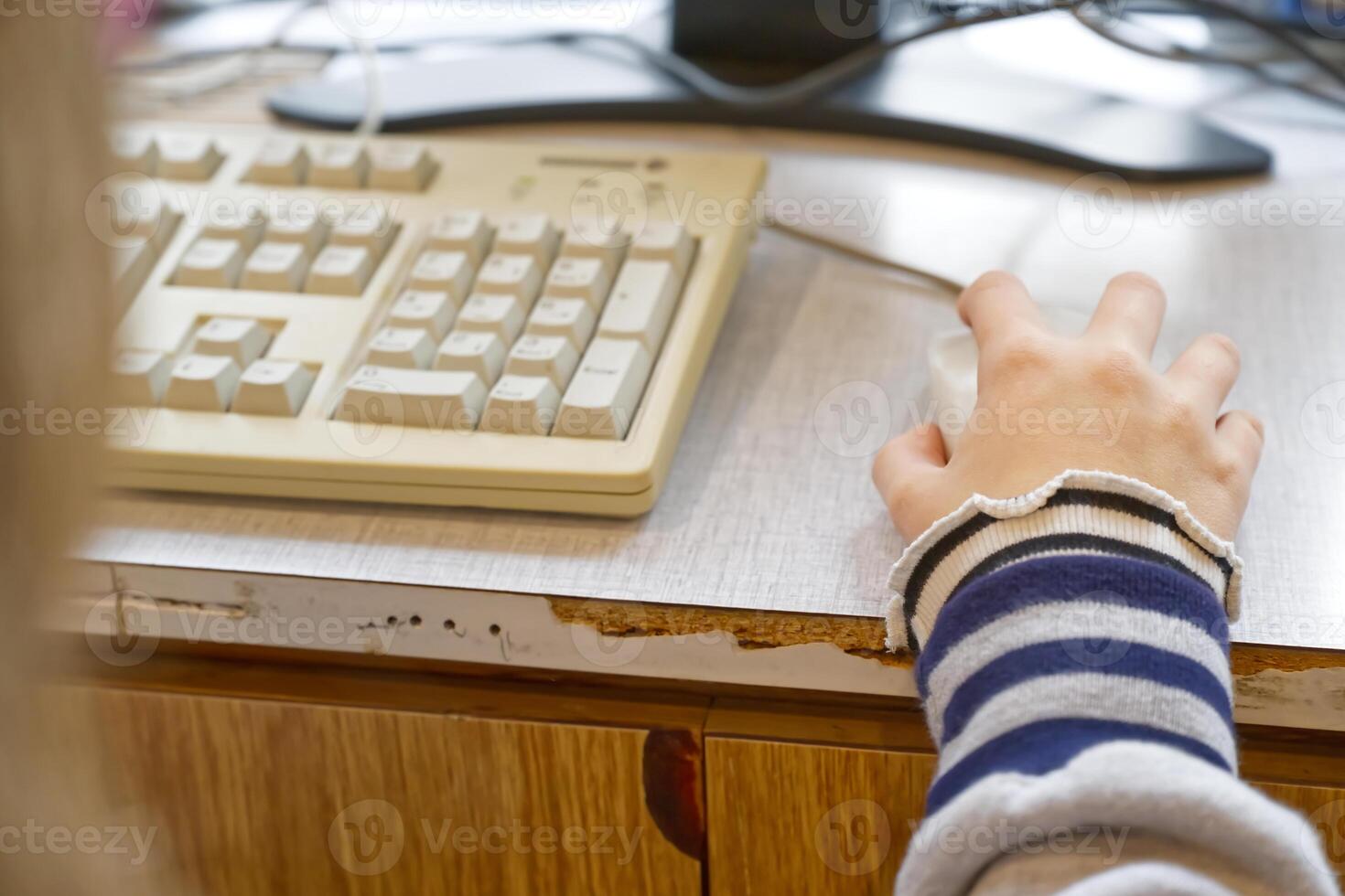 Close-up of Hand Using Computer Mouse and Keyboard photo