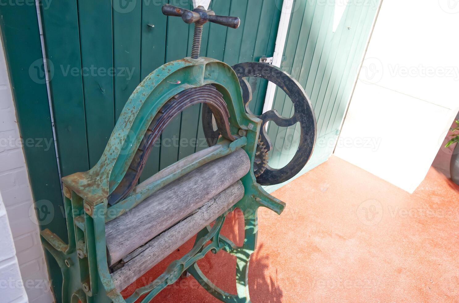 Antique Green Printing Press Against Door photo