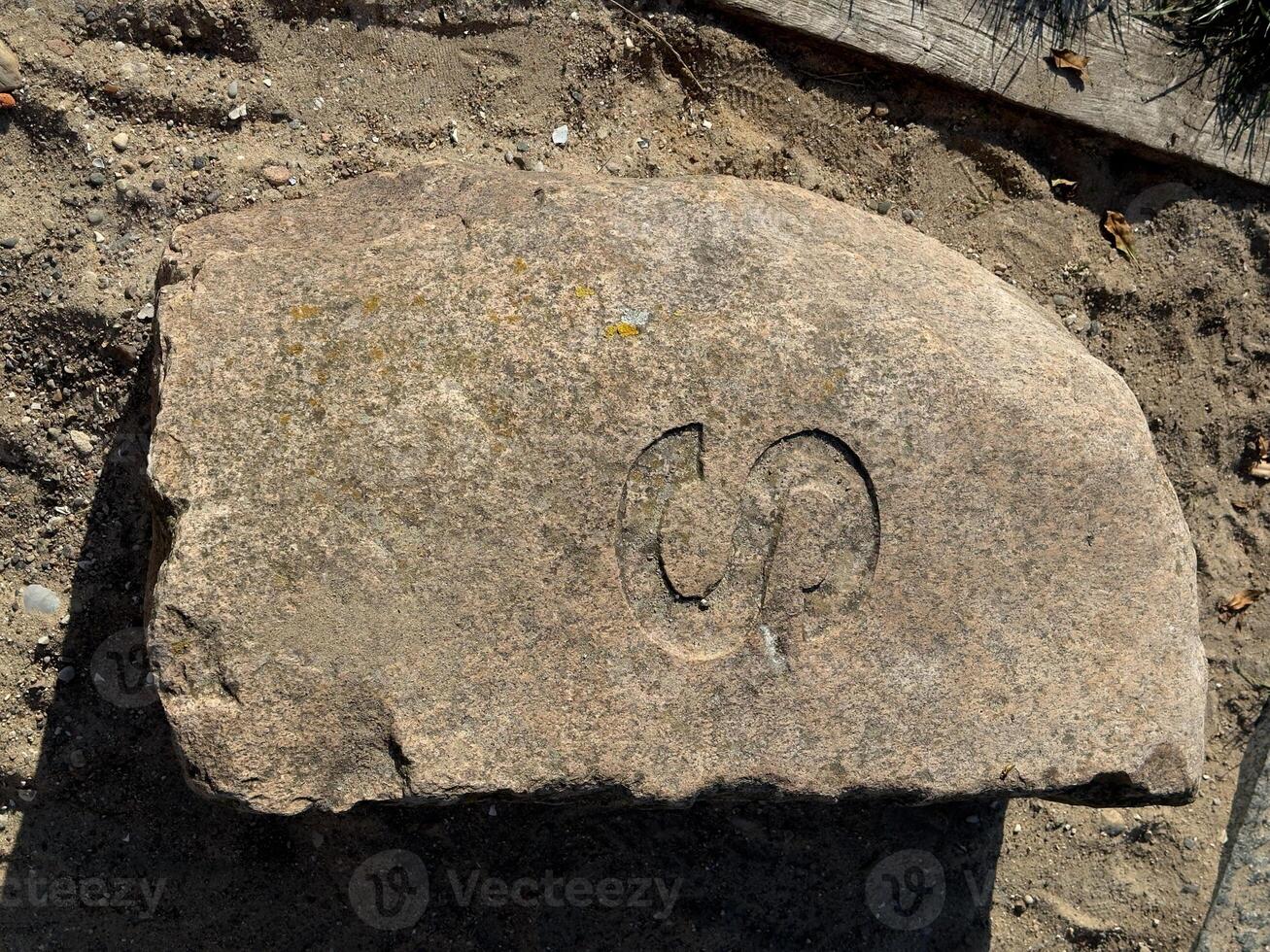 Carved Stone with Stylized Symbol photo