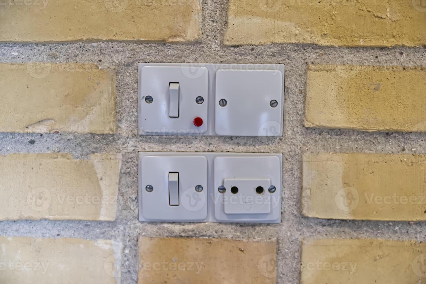 Danish Electrical Switches and Socket on Brick Wall photo