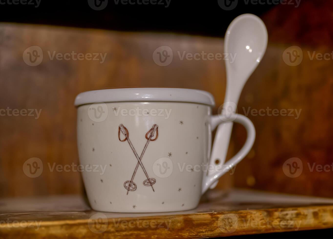 Decorative White Ceramic Cup with Spoon photo