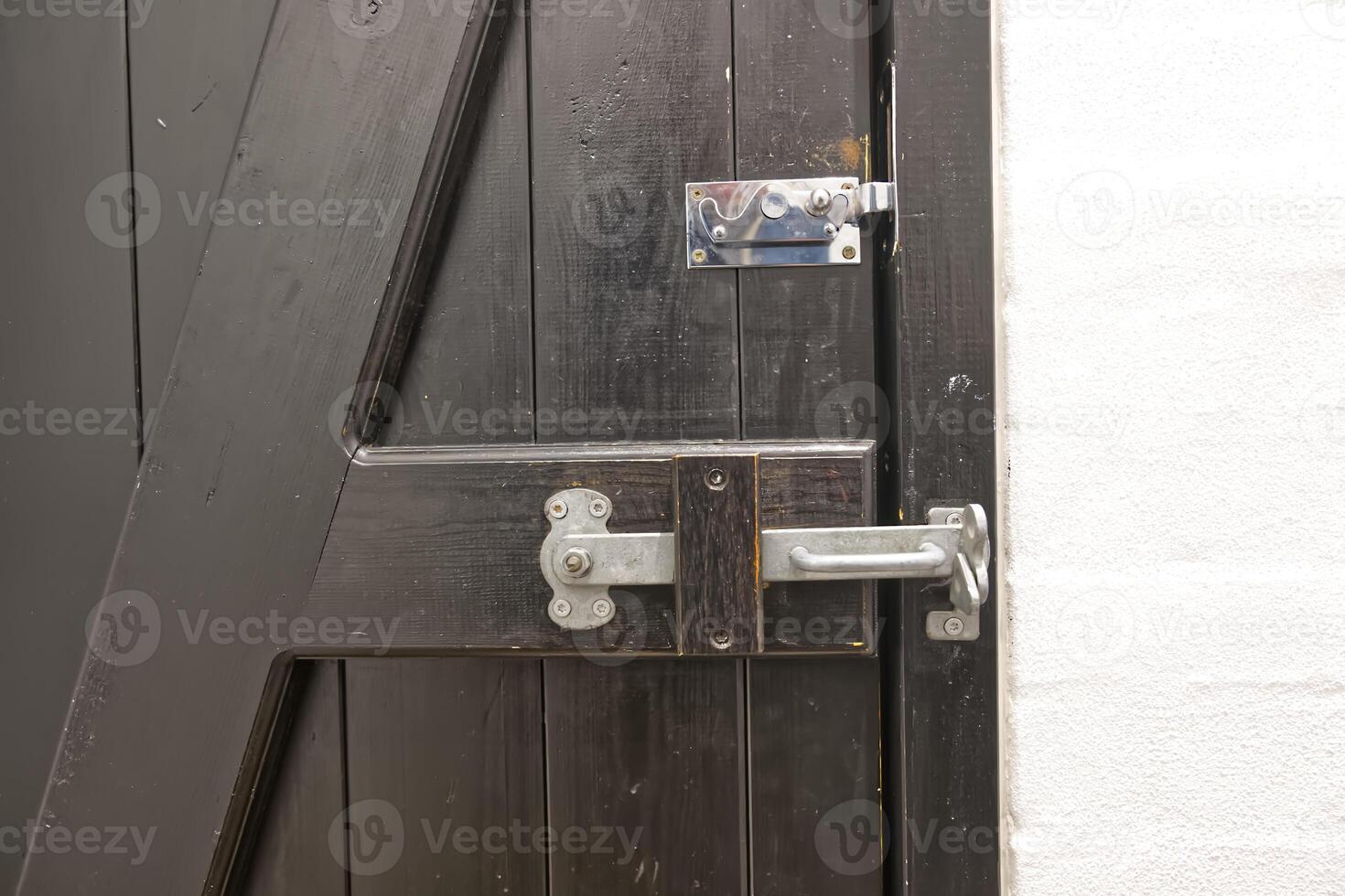 Close-Up of Rustic Wooden Door with Metal Latch photo