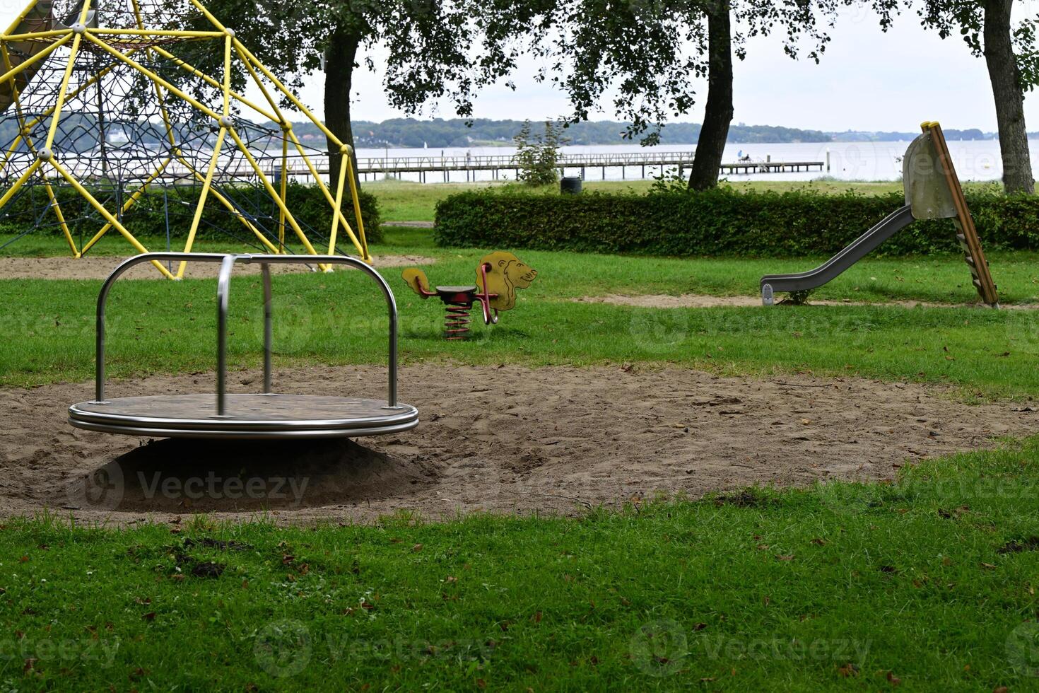 Playground with Merry-Go-Round and Lake View photo