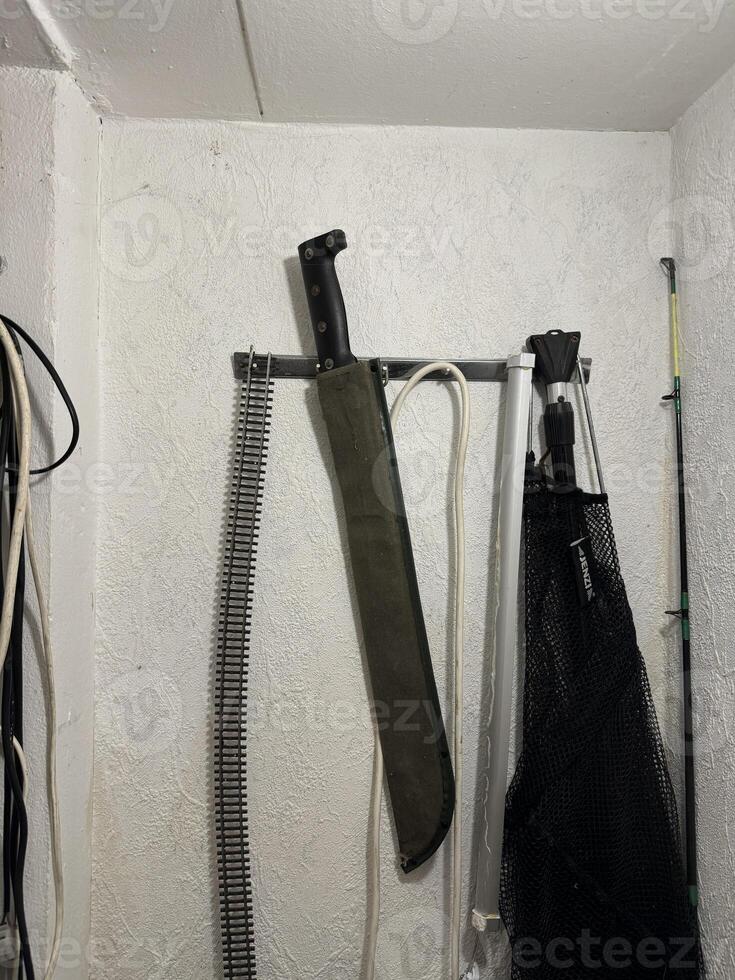 Machete Mounted on Wall in Storage Area photo