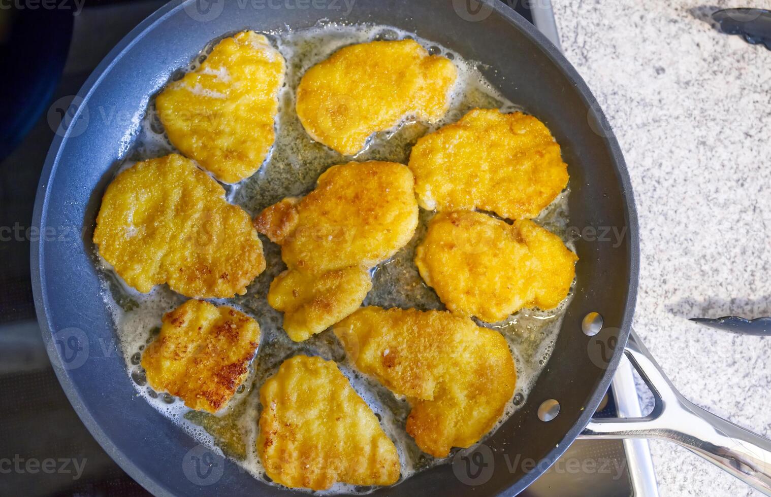Crispy Chicken Nuggets Frying in a Pan photo
