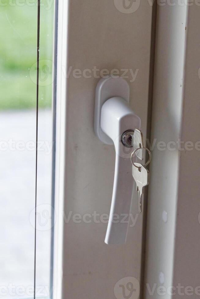 Close Up of a White Door Handle with Key photo