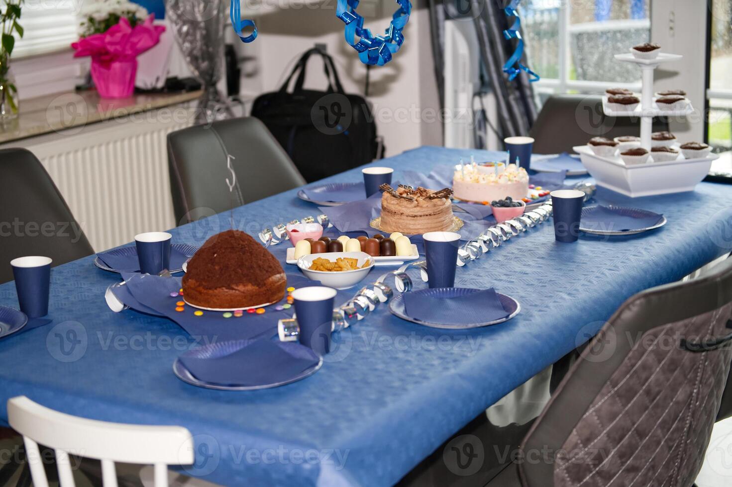 Festive blue Birthday Celebration Table with Cakes and Snacks photo