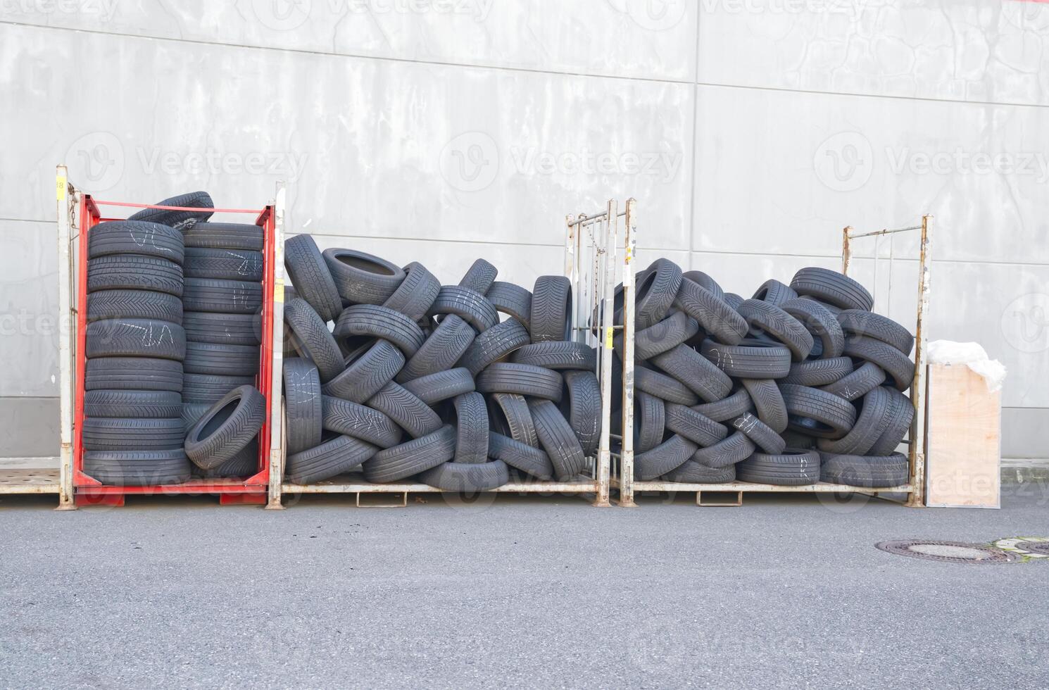 Stack of Used Tires on Metal Racks photo