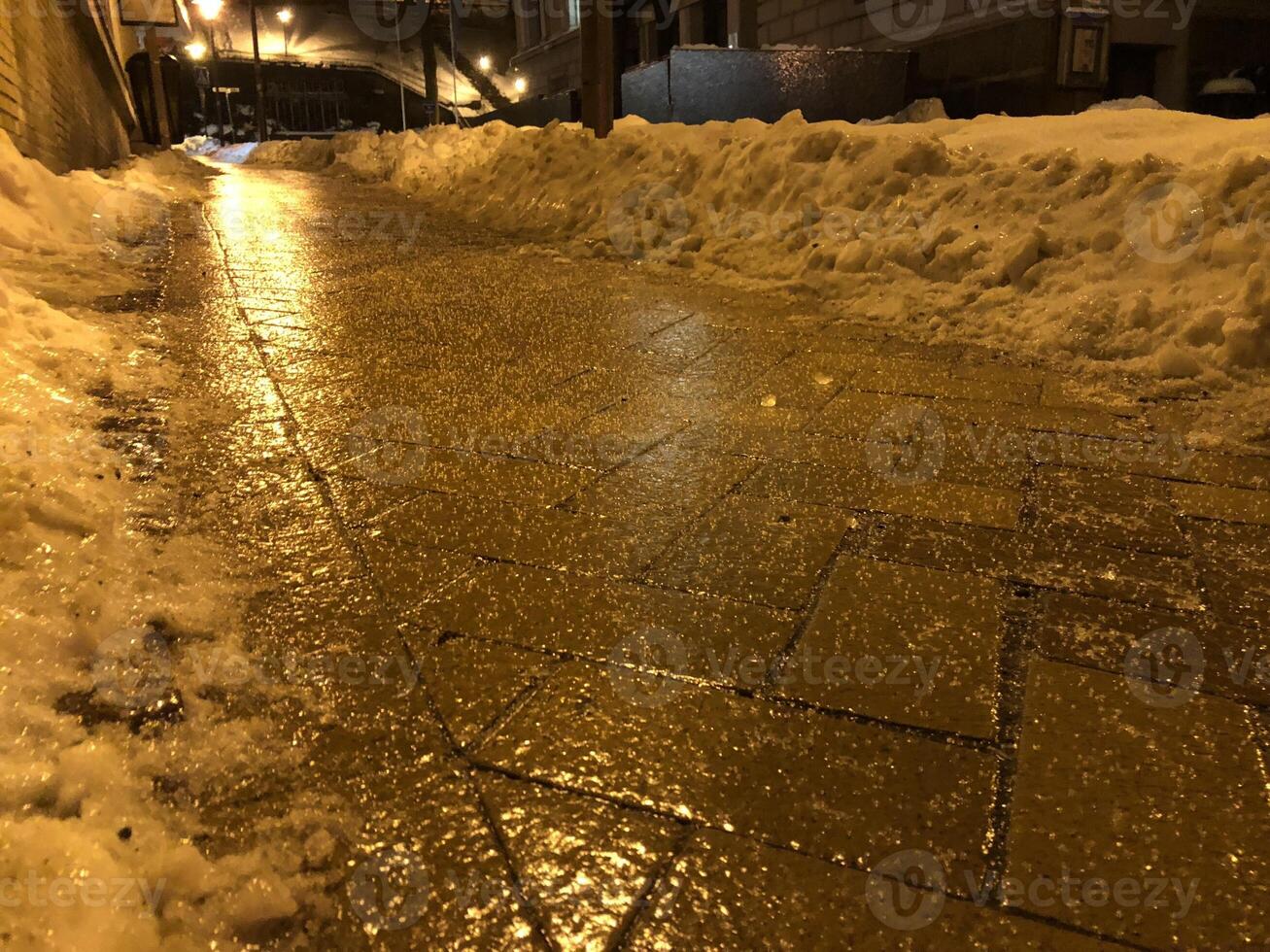 Frozen and dangerous Sidewalk at Night with Snow photo