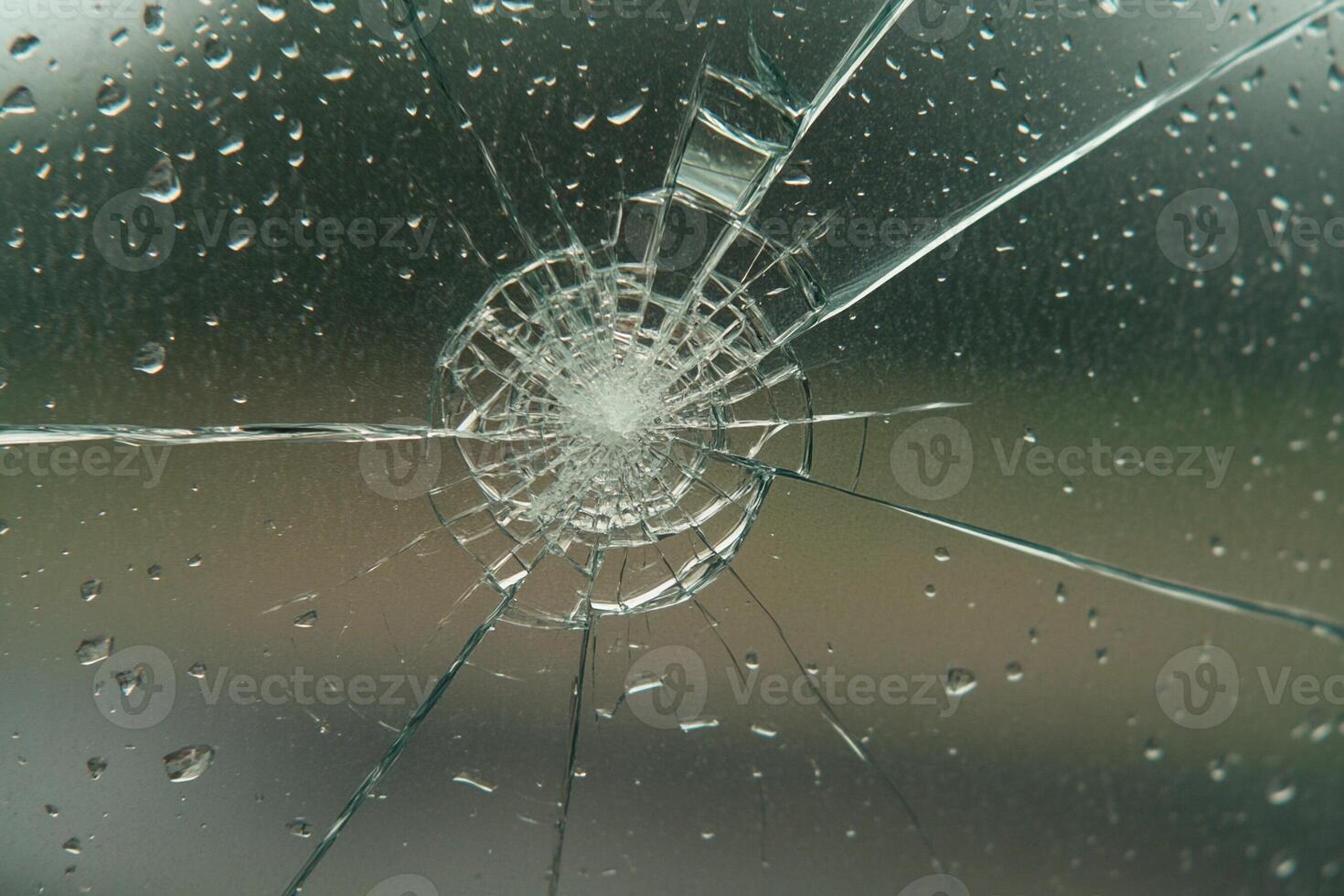 A broken window with rain drops on it photo