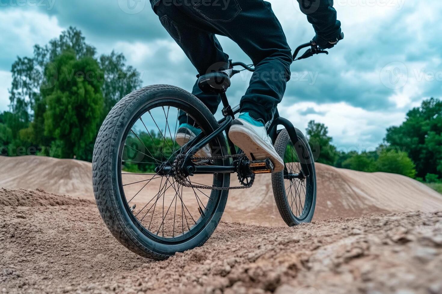 A person riding a bike on a dirt track photo