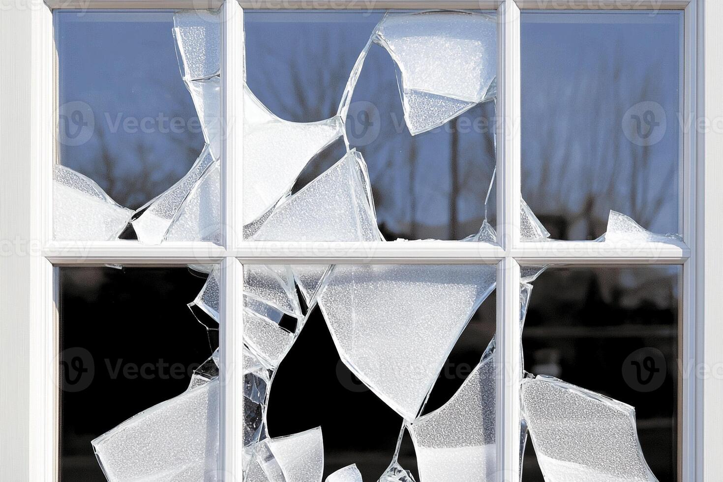 A broken window with a broken pane of glass photo