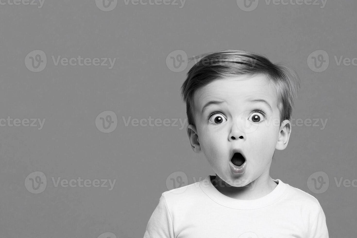 A young boy is making a surprised face photo