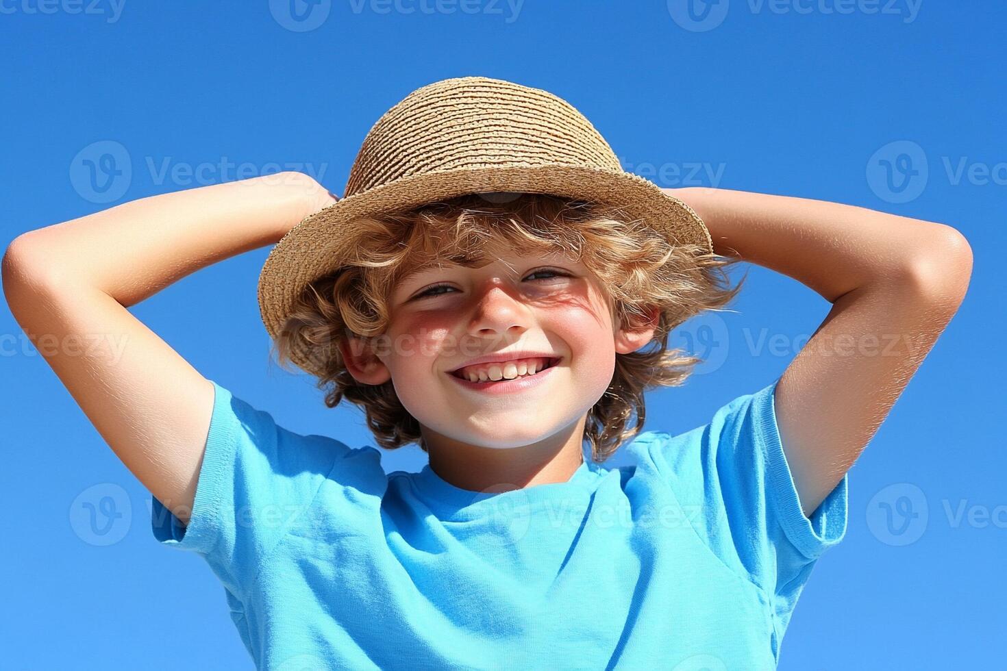 A young boy wearing a hat and smiling photo