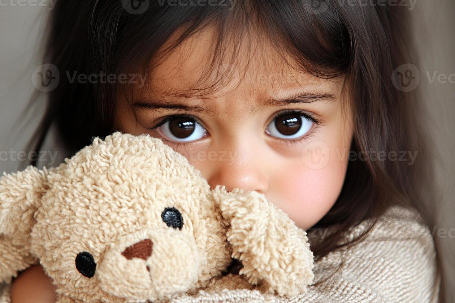 A little girl holding a teddy bear photo