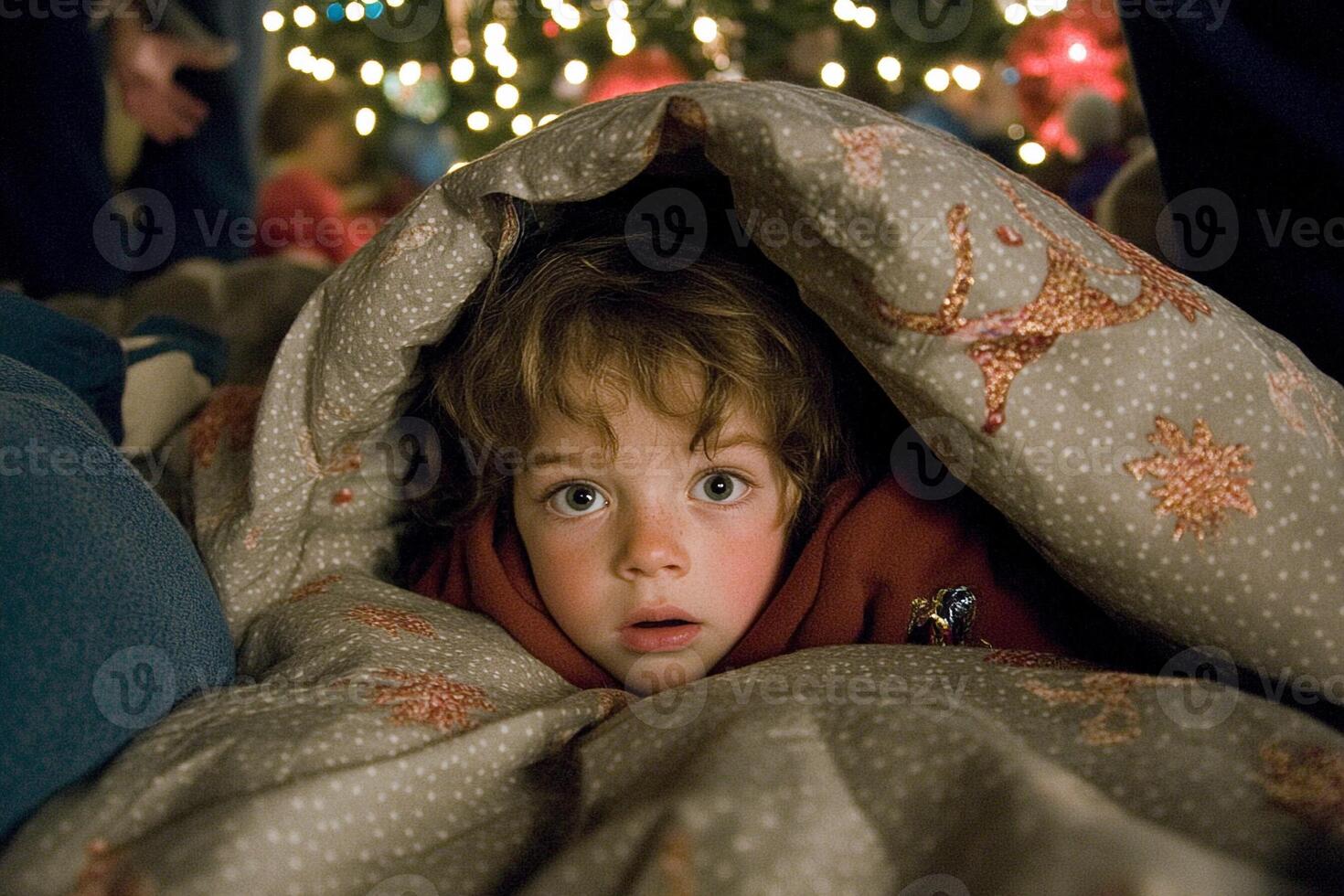 A young child under a blanket photo
