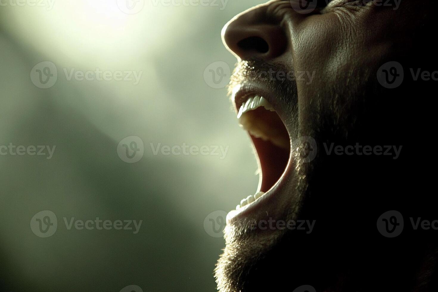 A man with his mouth open and his teeth showing photo
