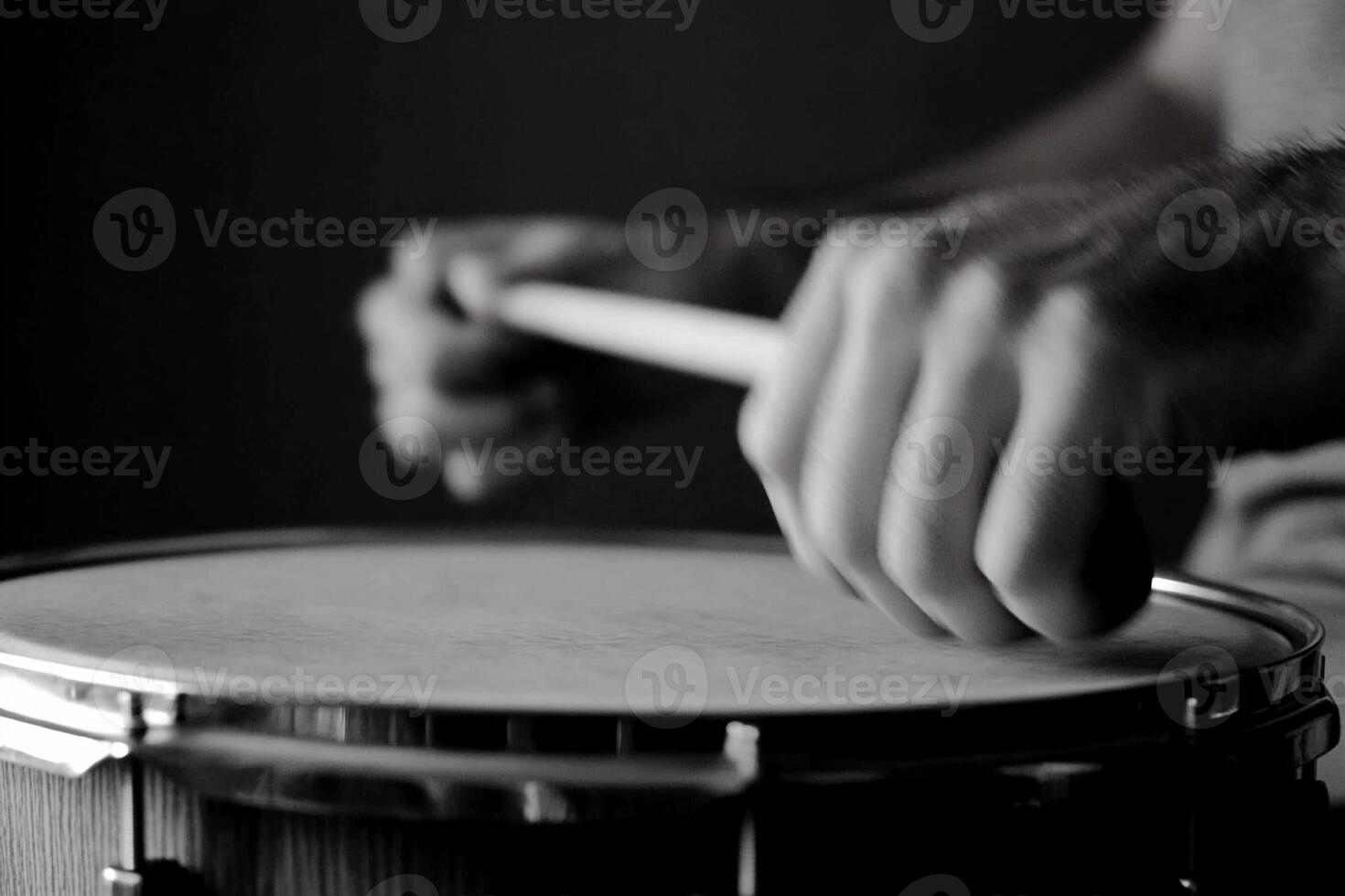 A person playing a drum with their hands photo