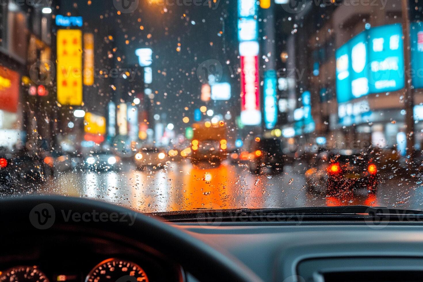 A view of the dashboard of a car on a rainy night photo