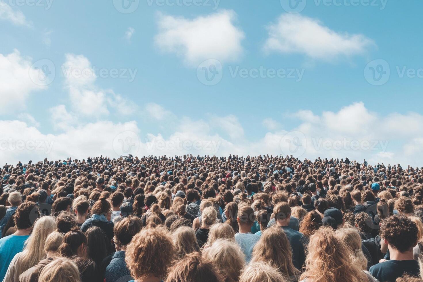 A large crowd of people standing in front of a blue sky photo