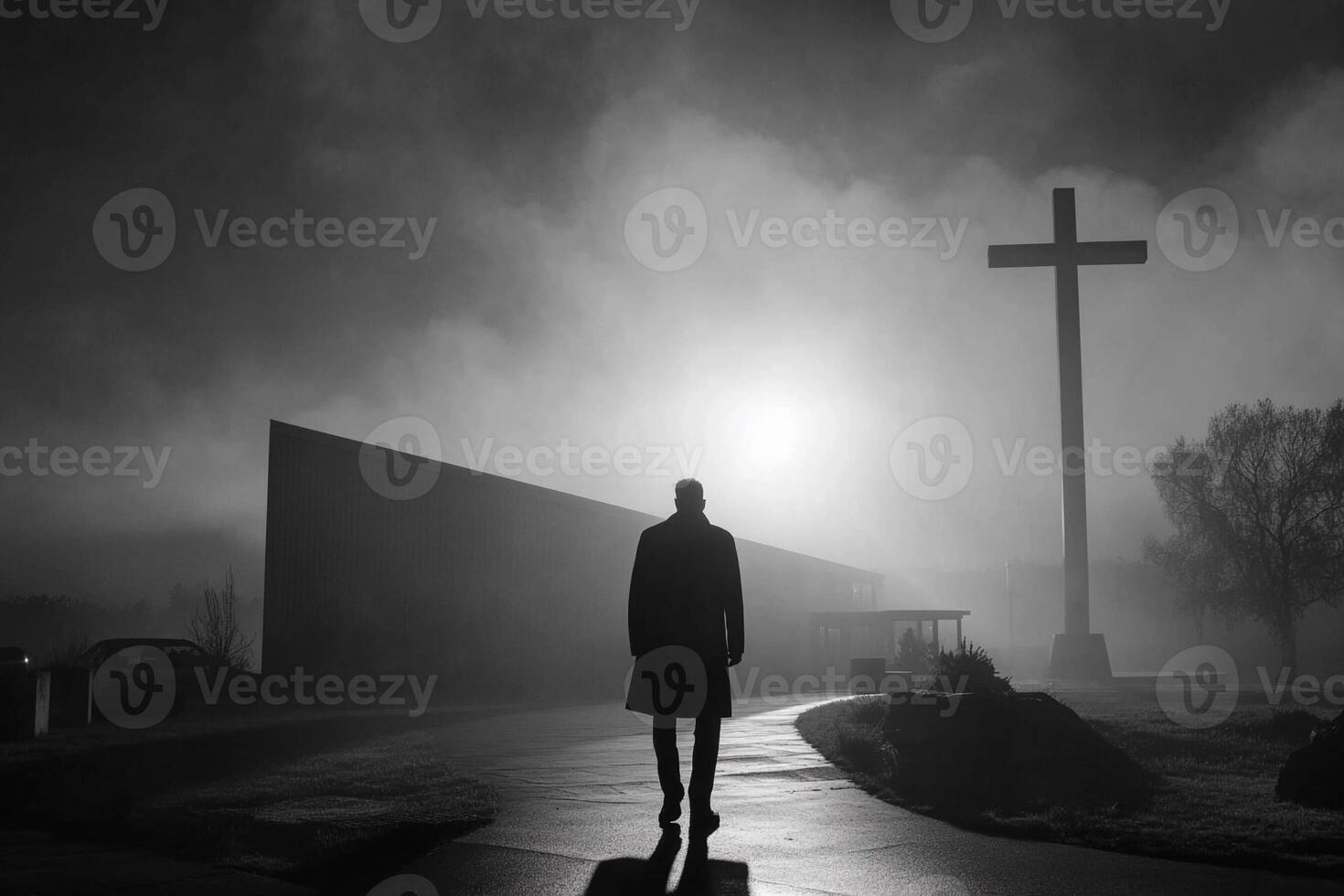 A man walks in front of a church at night photo