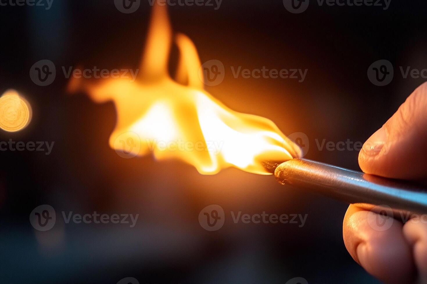 A person holding a lighter with a flame photo
