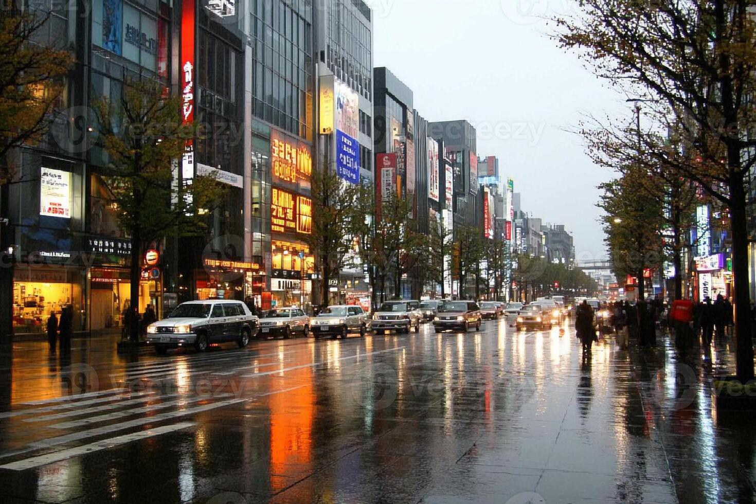 A rainy city street with cars and pedestrians photo