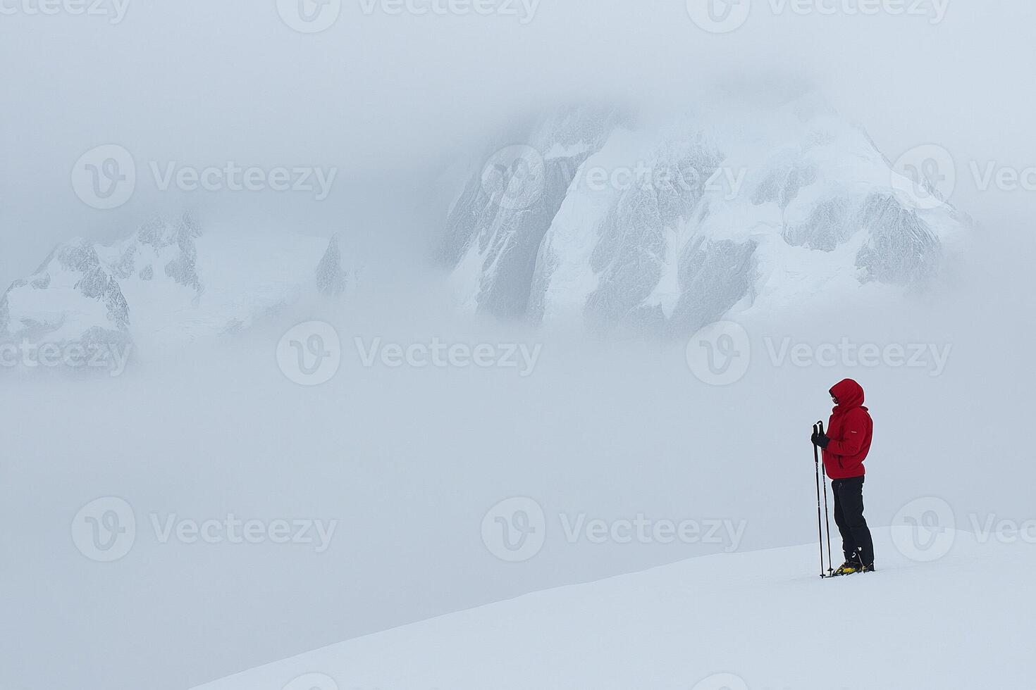 A person standing on a mountain top photo